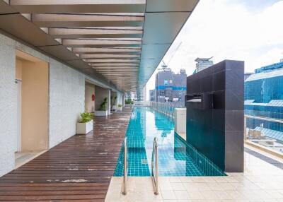 Rooftop swimming pool with decking and skyline view