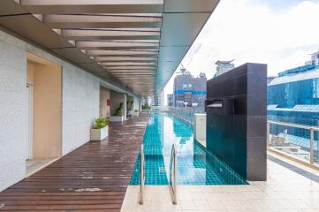 Rooftop swimming pool with decking and skyline view