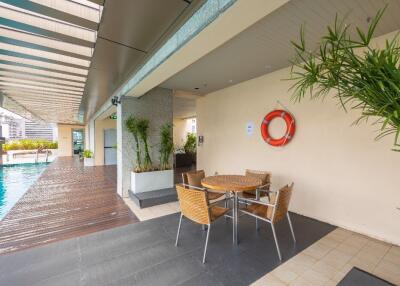 Outdoor pool area with seating arrangement