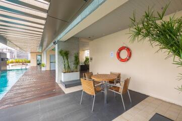 Outdoor pool area with seating arrangement