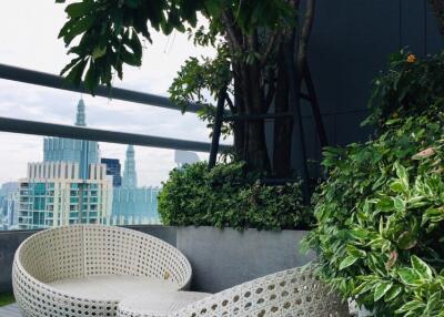 Outdoor seating area with city view and greenery