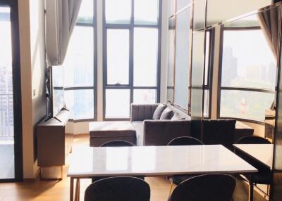 Modern living room with large windows and city view