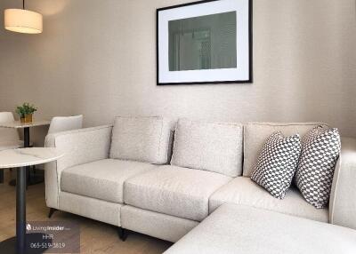 Modern living room with light gray sofa and framed artwork