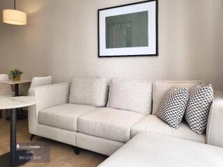 Modern living room with light gray sofa and framed artwork