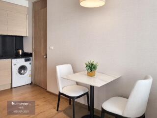 Small kitchen area with dining table and chairs