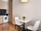 Small kitchen area with dining table and chairs