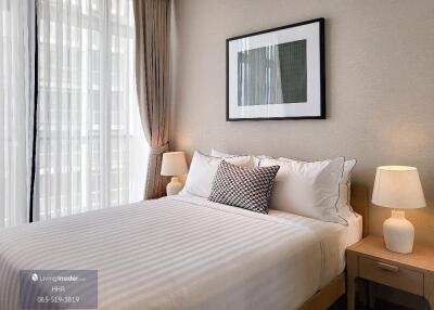 Well-lit bedroom with a double bed, bedside tables, and lamps