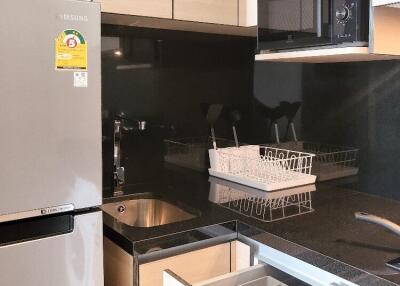 Modern kitchen with stainless steel appliances and black countertop