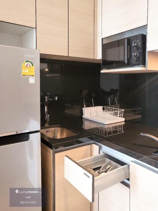 Modern kitchen with stainless steel appliances and black countertop