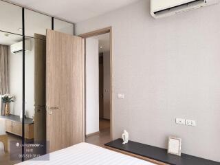 Modern bedroom with air conditioner and wooden door