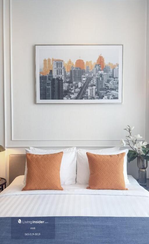 Well-decorated bedroom with modern art and plush pillows