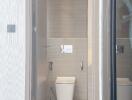 Modern bathroom with gray tiles and white sanitary fixtures