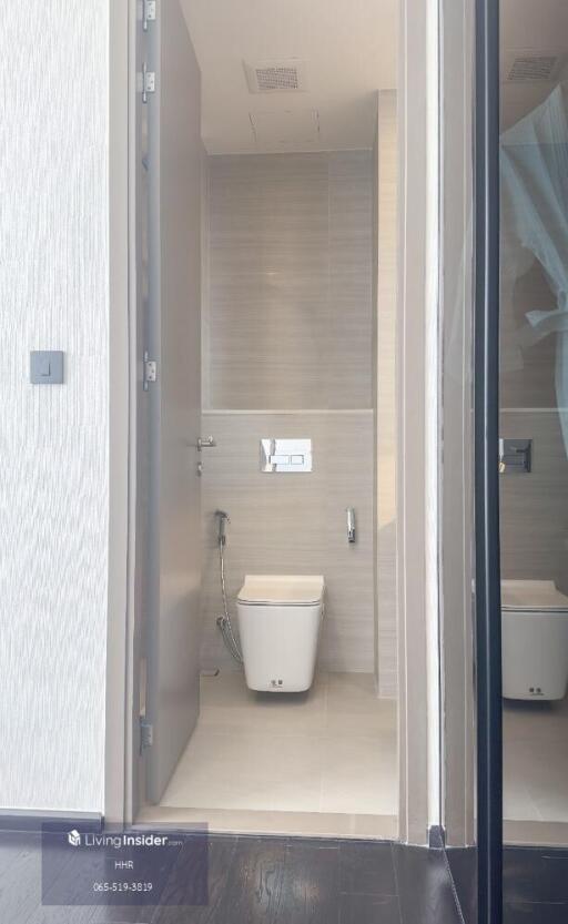 Modern bathroom with gray tiles and white sanitary fixtures