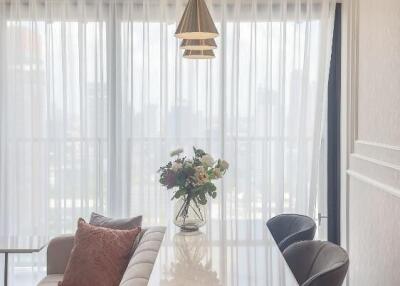 Modern dining area with table, chairs, and window view