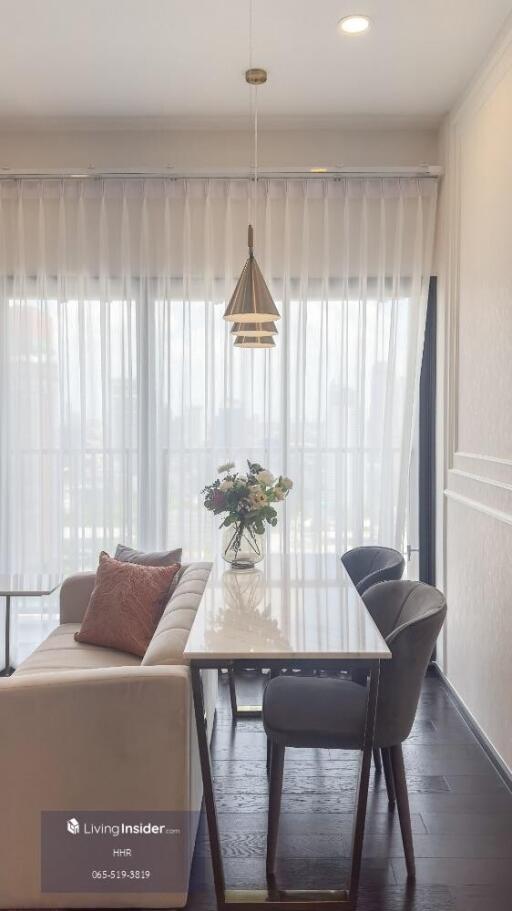 Modern dining area with table, chairs, and window view