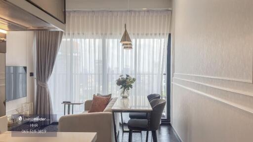 Modern living room with a dining area and large window