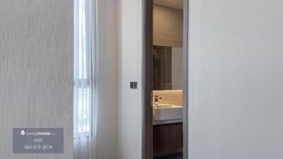 Modern bathroom view with sink and partial mirror visible