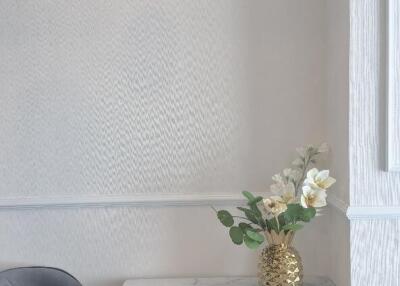 Small dining area with a marble table and flower vase