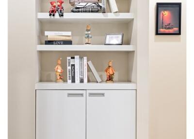 Built-in wall shelves with decor and cabinet storage 