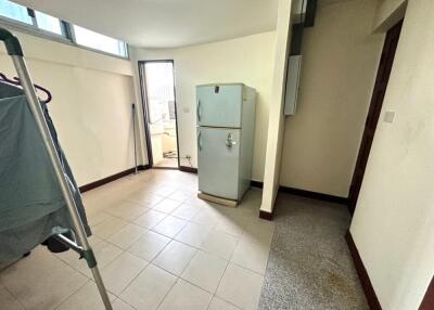 Kitchen with refrigerator and laundry area