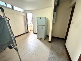 Kitchen with refrigerator and laundry area