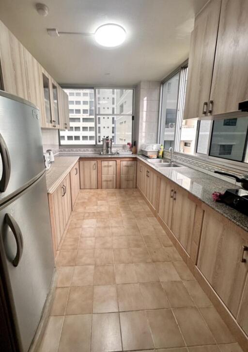 Modern kitchen with ample storage and large windows