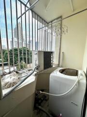 Laundry area with a washing machine and view of high-rise buildings