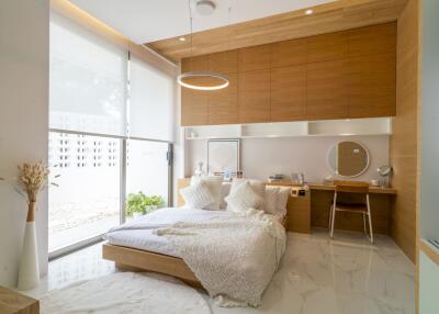 Spacious and modern bedroom with large window and ample natural light