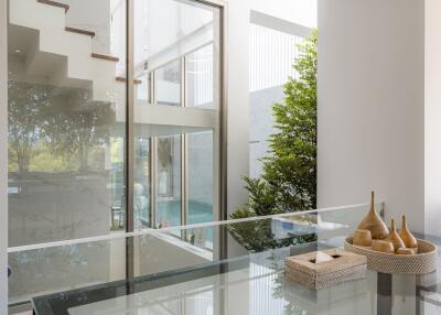 Modern living area with glass walls and staircase