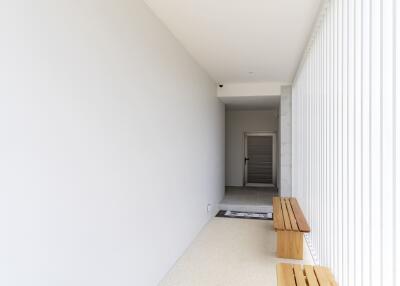 Bright hallway with minimalist wooden benches and light walls