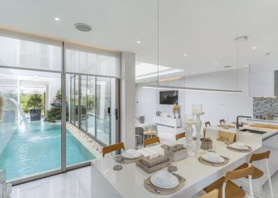 Modern kitchen and dining area with pool view