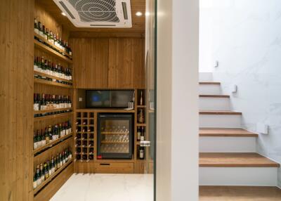 Modern wine cellar with built-in wooden racks and wine cooler