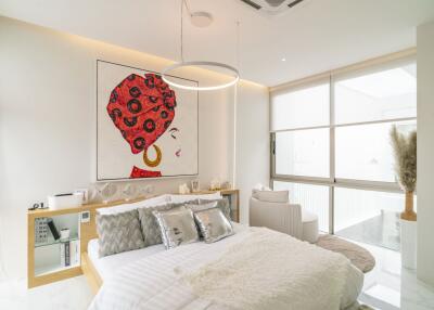 Modern bedroom with contemporary decor and large window