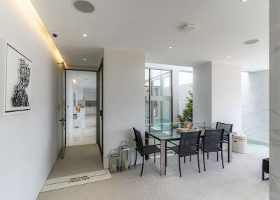 Modern dining area with glass table and elegant decor