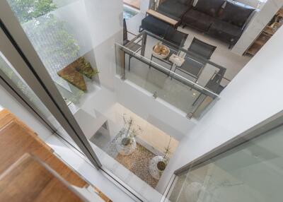 Modern living room with staircase and glass railing