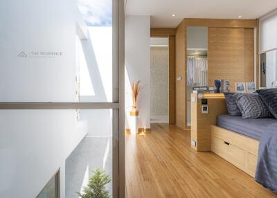 Modern bedroom with wooden flooring and bright natural lighting