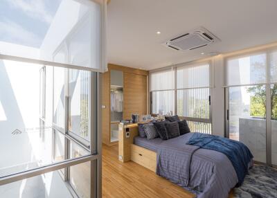 Modern bedroom with large windows and natural light