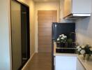 Modern compact kitchen with appliances and floral decorations