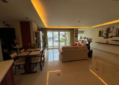 A cozy living room with dining area and modern lighting