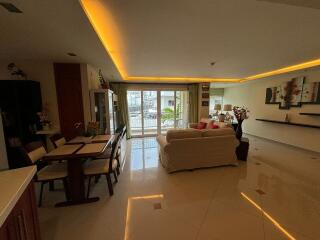 A cozy living room with dining area and modern lighting