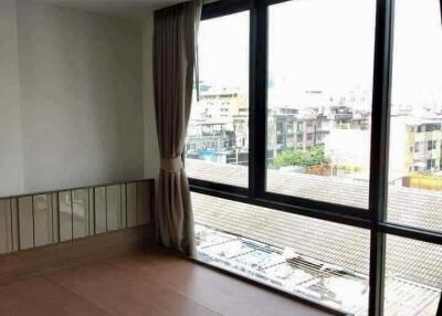 Modern bedroom with large window and built-in wooden bedframe