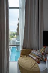 Cozy bedroom corner with pool view