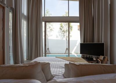 Modern bedroom with a view of private pool