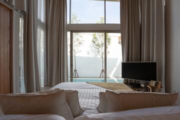 Modern bedroom with a view of private pool