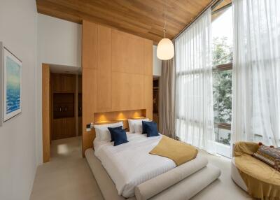 A modern bedroom with large windows and wooden accents