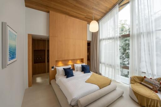 A modern bedroom with large windows and wooden accents