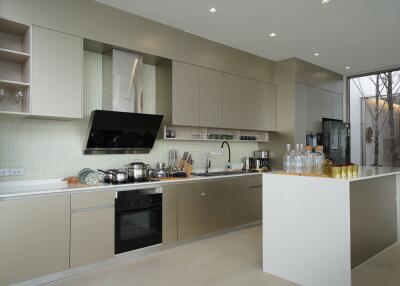 Modern kitchen with beige cabinetry and island