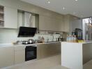 Modern kitchen with beige cabinetry and island