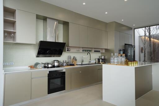 Modern kitchen with beige cabinetry and island