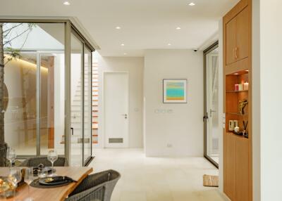 Modern dining area with glass doors and natural lighting